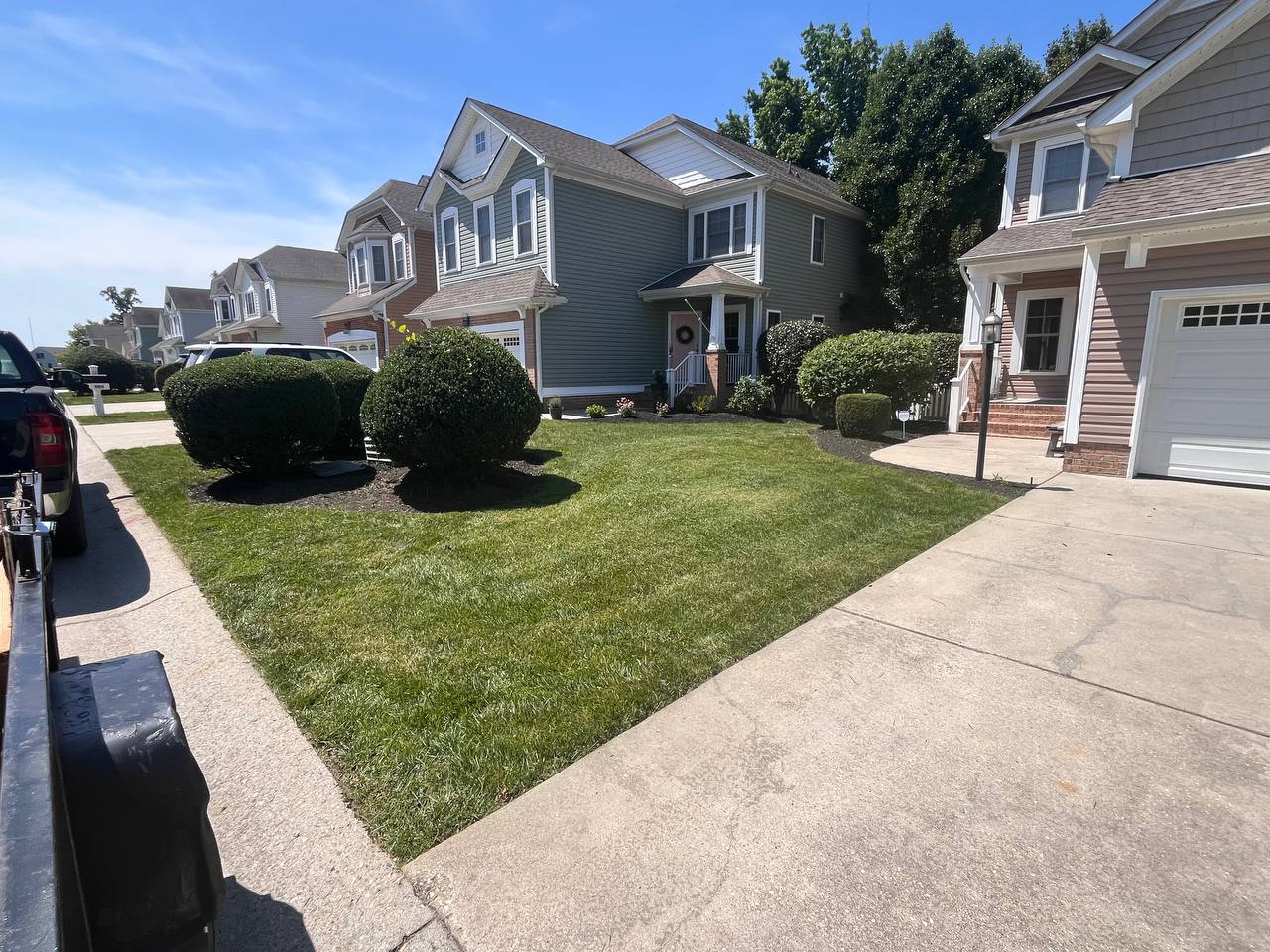 Freshly maintained lawn and landscaped mulch beds in a Richmond neighborhood